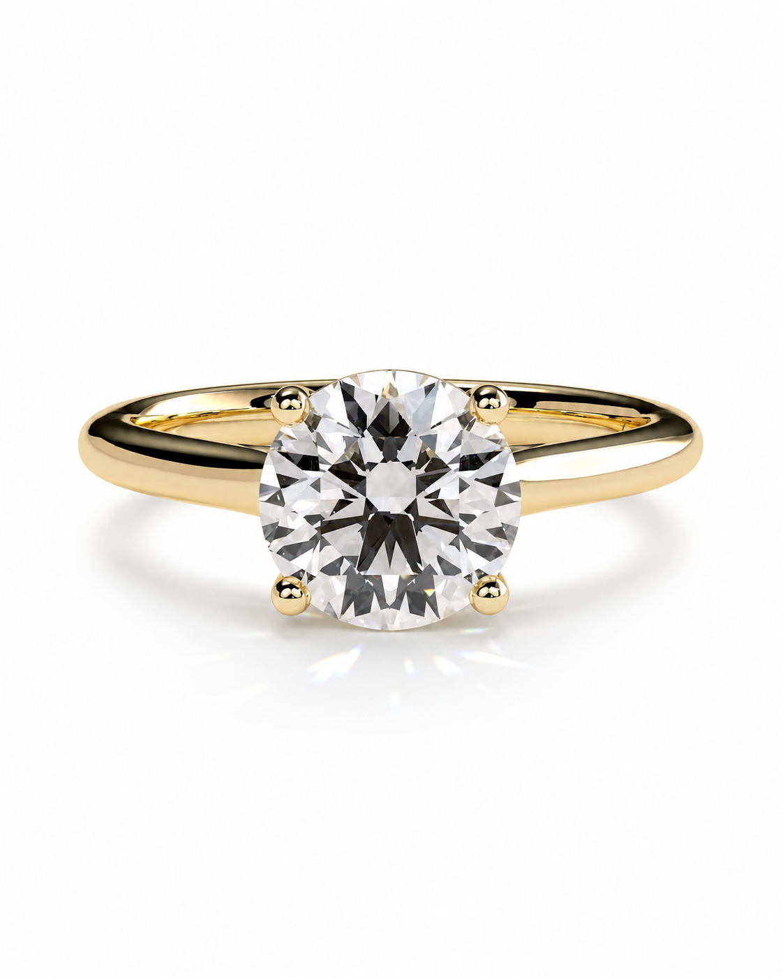 color_10K_YG, color_14K_YG &&	
A classic solitaire engagement ring featuring a round brilliant-cut diamond set in a yellow gold four-prong band, shown on a clean white background with a soft reflection.