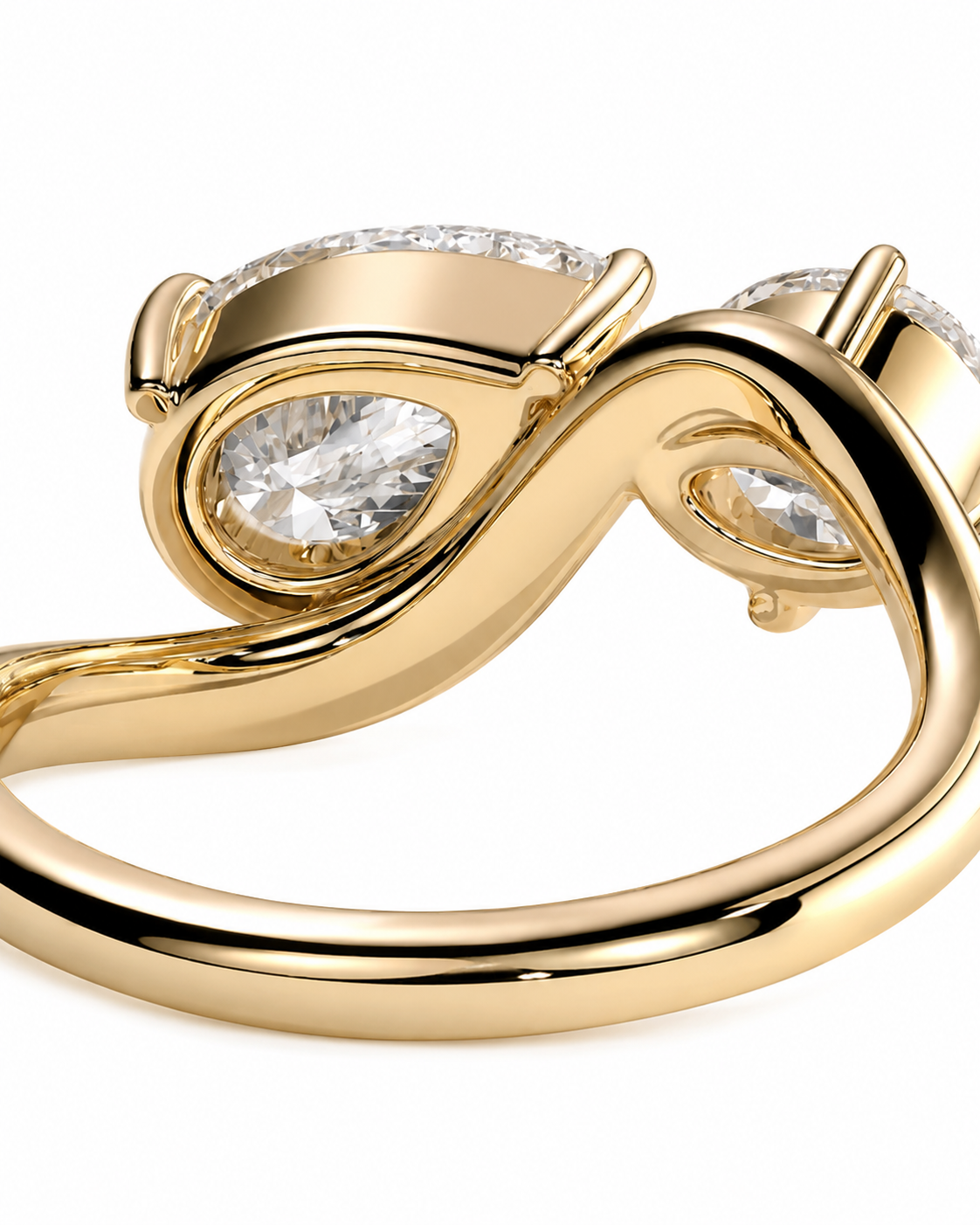 color_10K_YG, color_14K_YG &&	
A close-up of a gold infinity-style ring featuring pear-cut clear gemstones and small accent stones, shown on a white background.