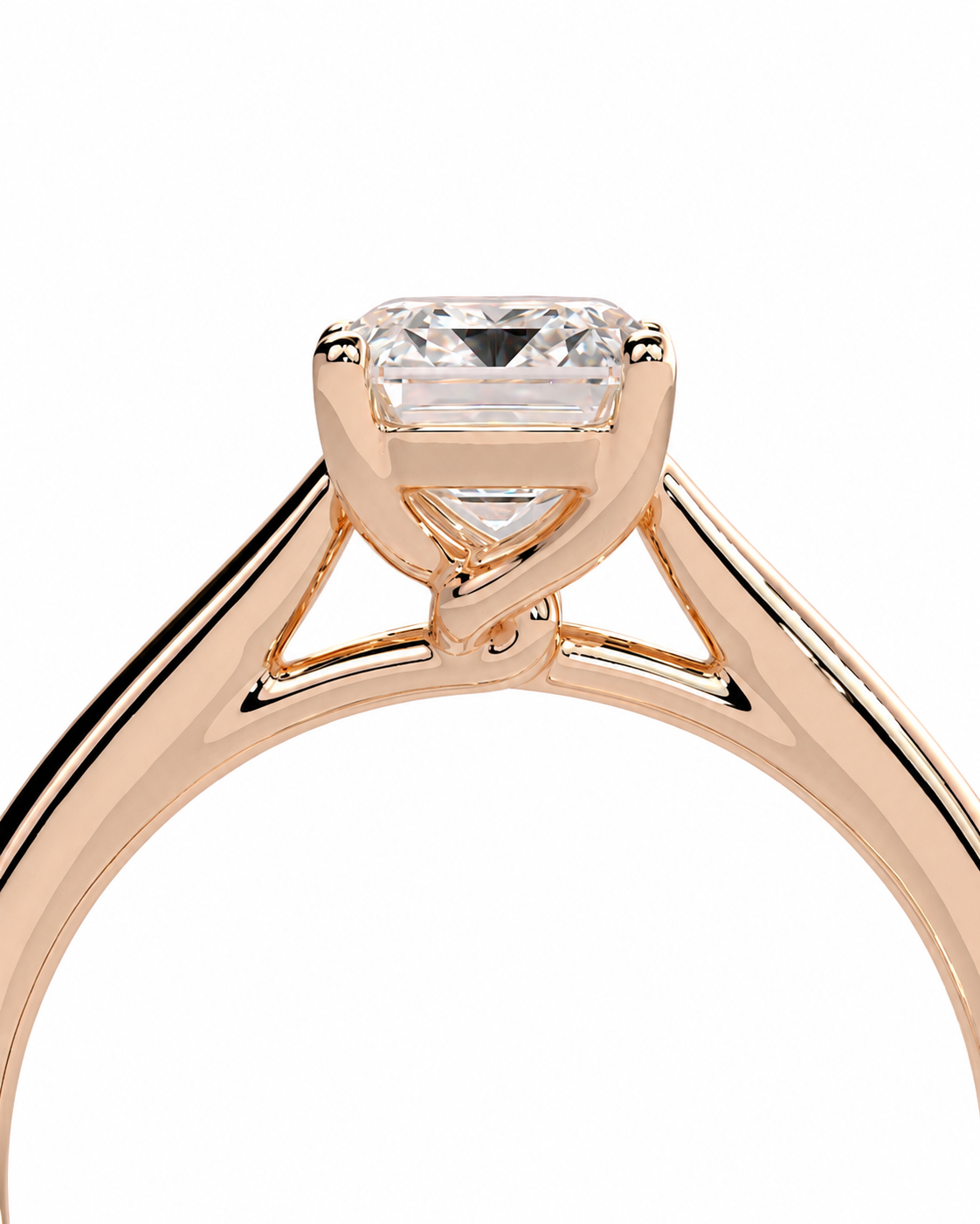 color_10K_RG, color_14K_RG &&	A close-up of a rose gold engagement ring featuring a rectangular emerald-cut clear center stone in a four-prong setting, shown against a solid white background.