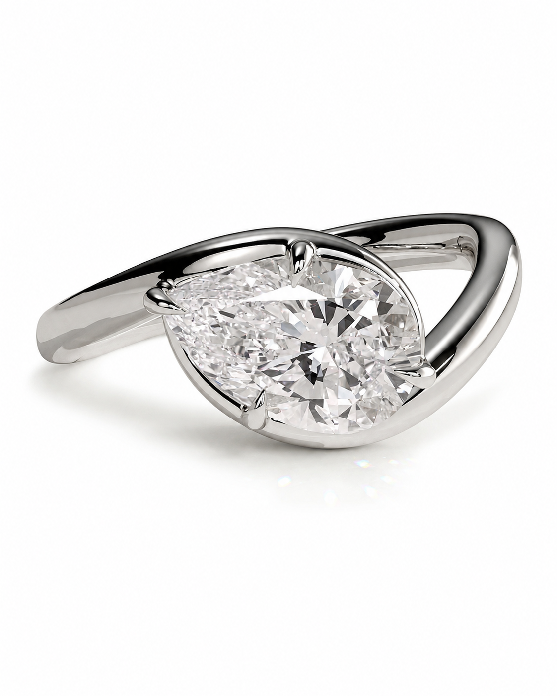 color_925_SIL,color_935_ARG,color_10K_WG, color_14K_WG &&
A silver-tone ring featuring a large pear-cut clear gemstone in a prong setting, with a curved, sculptural band, shown on a white background.