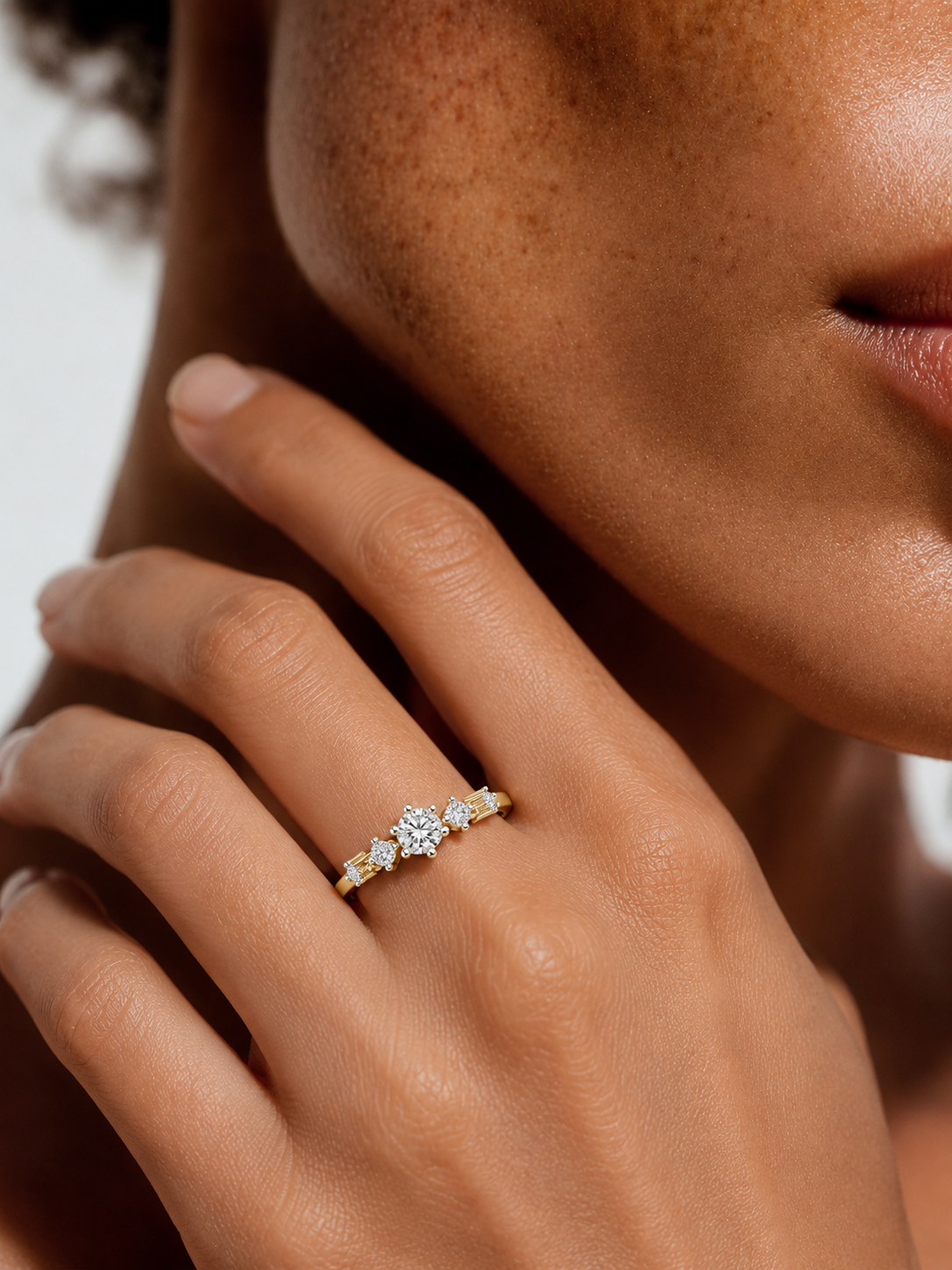 color_10K_YG, color_14K_YG &&Close-up of a women's curved moissanite wedding band with shared prong setting