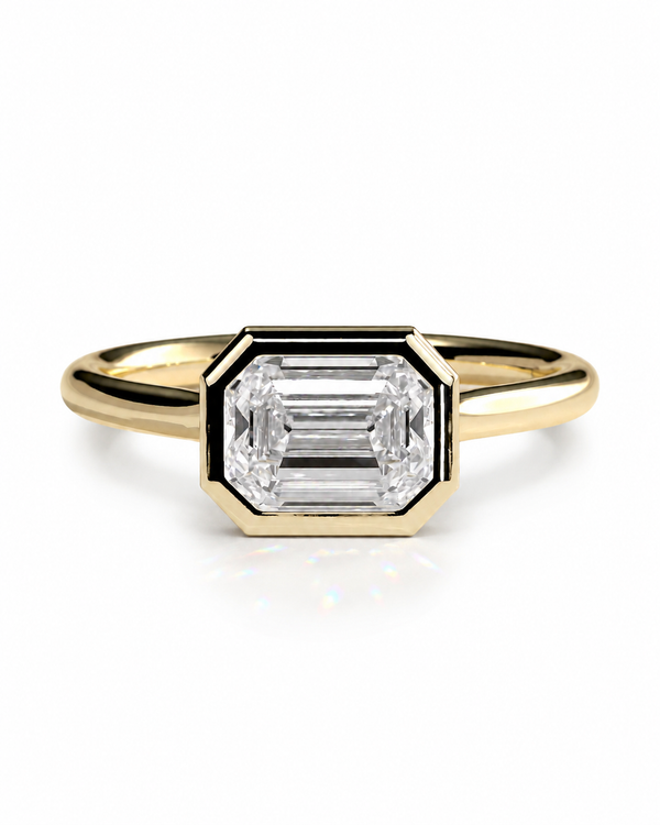 color_10K_YG, color_14K_YG &&	
A yellow gold ring featuring a large rectangular baguette-cut clear gemstone in a beveled octagonal setting, shown on a clean white background.