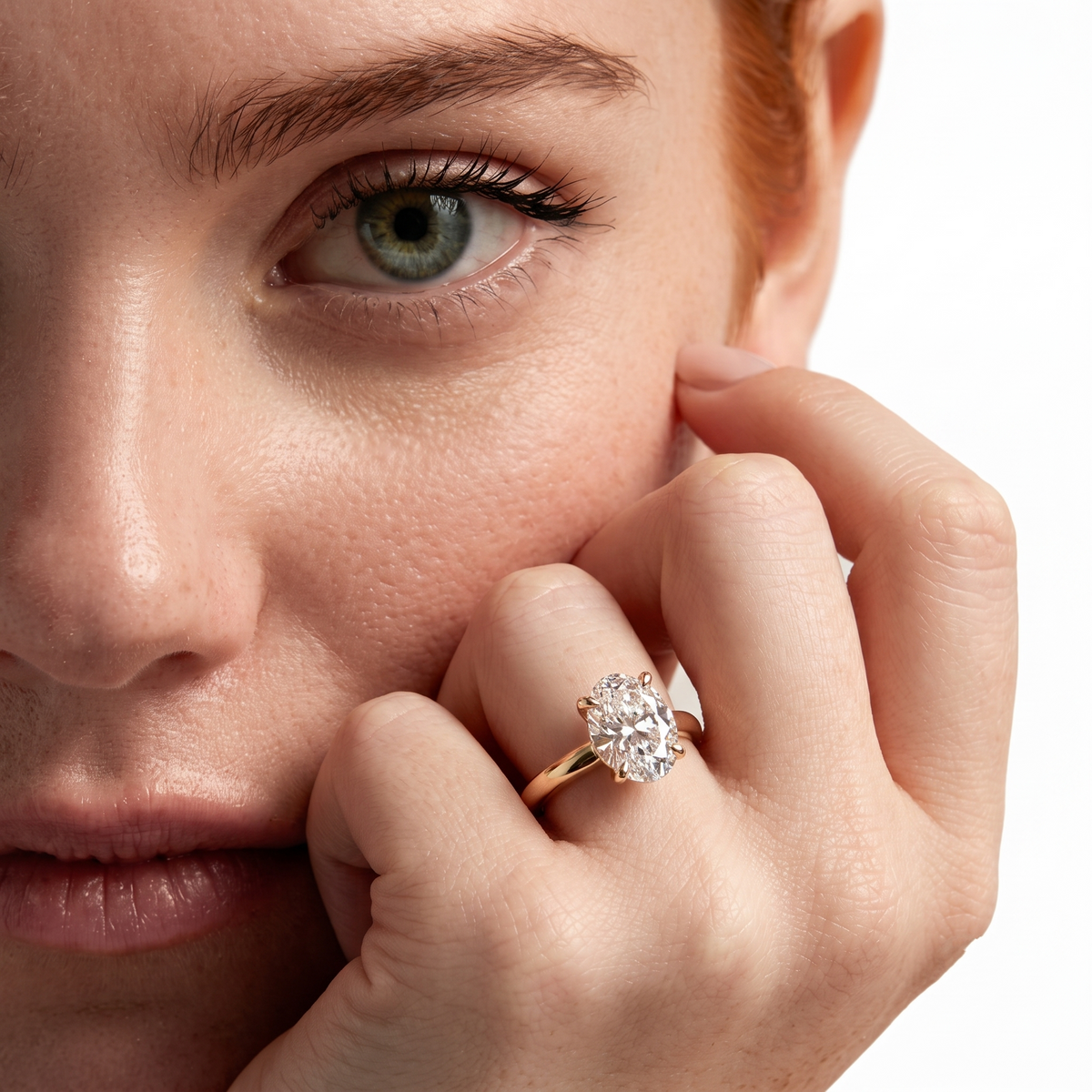 color_10K_YG, color_14K_YG &&	
A close-up lifestyle shot of a model wearing a yellow gold ring with a large round-cut clear gemstone on her finger, set against a clean white background.