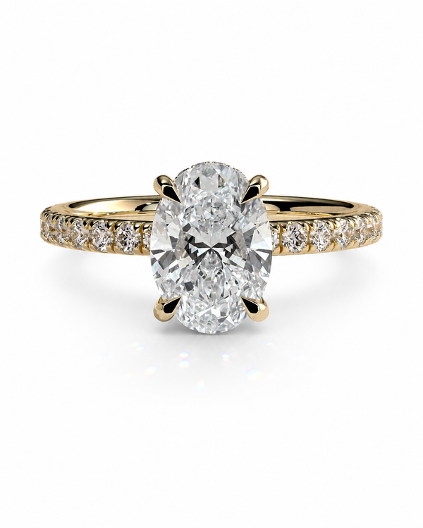 color_10K_YG, color_14K_YG &&	
An oval-cut diamond engagement ring with a yellow gold band paved with small round diamonds, shown on a clean white background.
