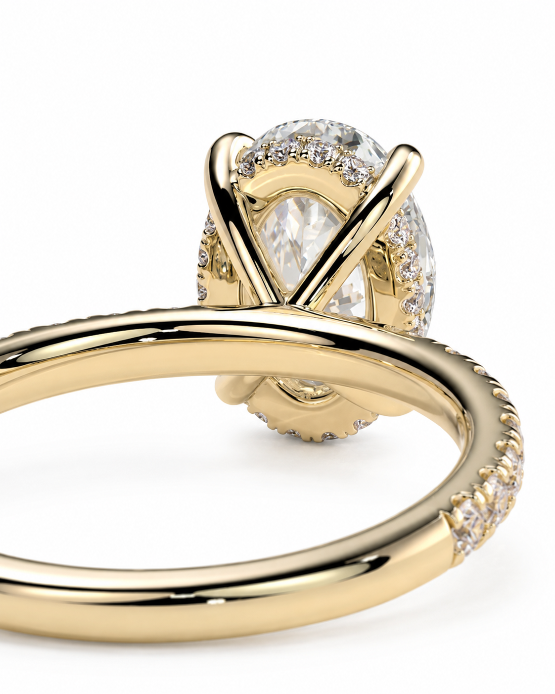 color_10K_YG, color_14K_YG &&	
A close-up of a yellow gold ring featuring a large pear-cut clear center stone surrounded by a halo of small clear stones, with additional small stones set along the band, shown on a white background.