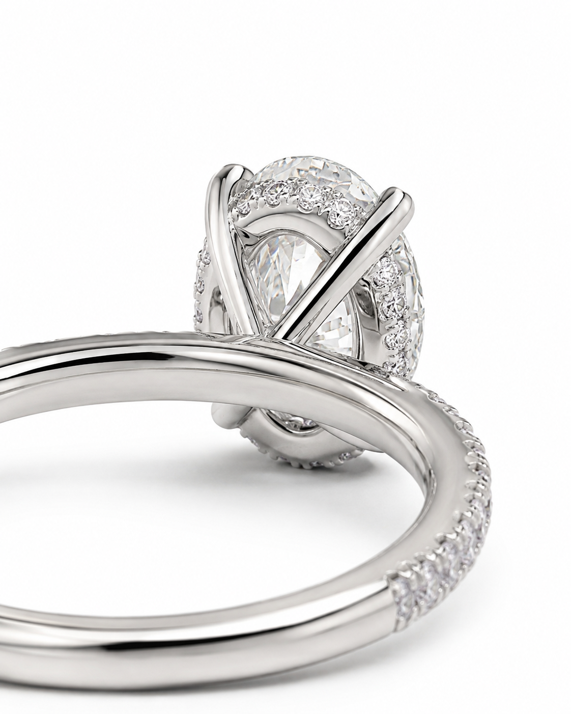color_925_SIL,color_935_ARG,color_10K_WG, color_14K_WG &&	
A close-up studio shot of a silver-toned ring featuring a marquise-cut center stone surrounded by a halo of small clear stones, with a curved pave band on a white background.