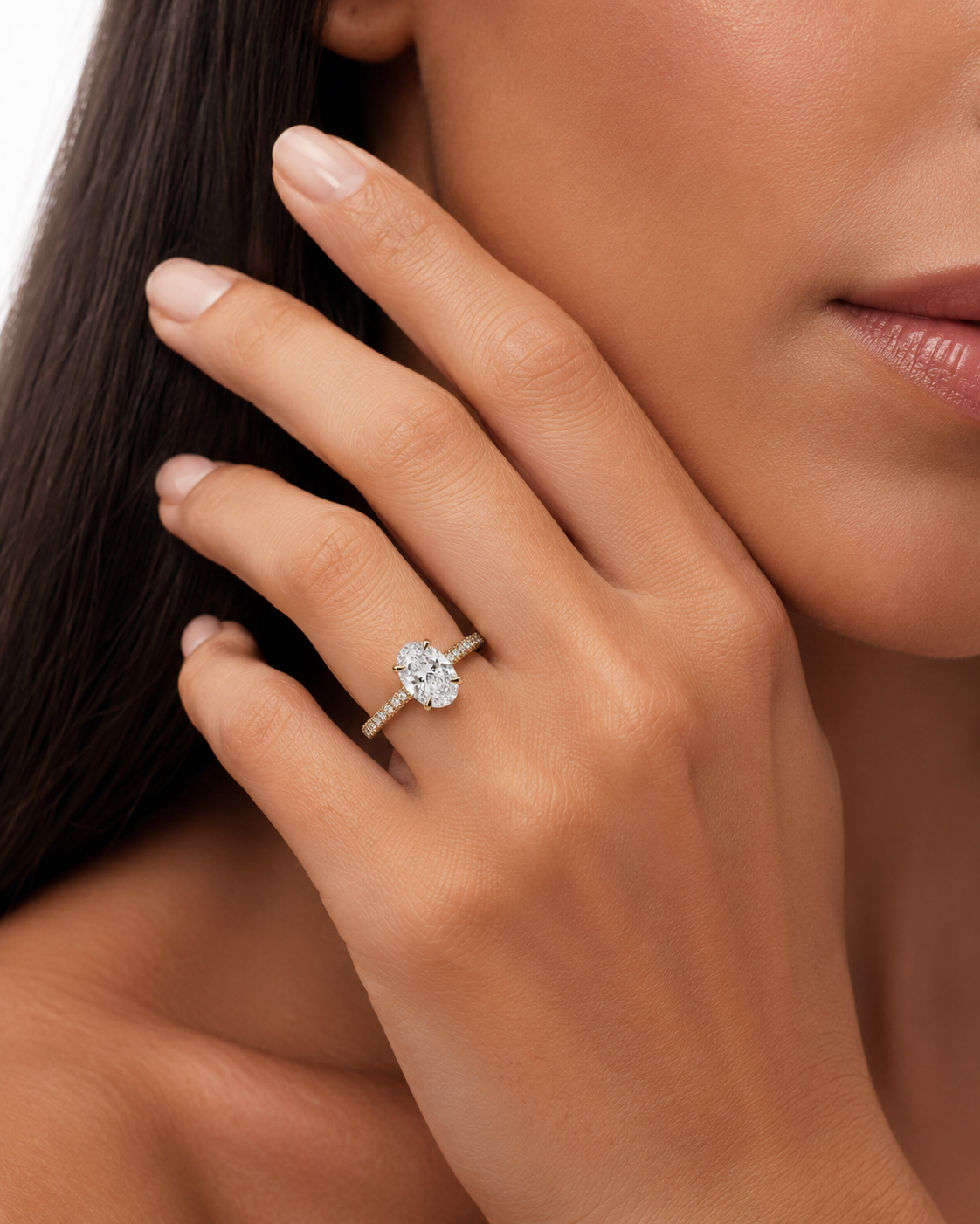 color_10K_YG, color_14K_YG &&	
A close-up lifestyle shot of a woman's hand wearing a diamond ring with a textured band, set against her face and hair.