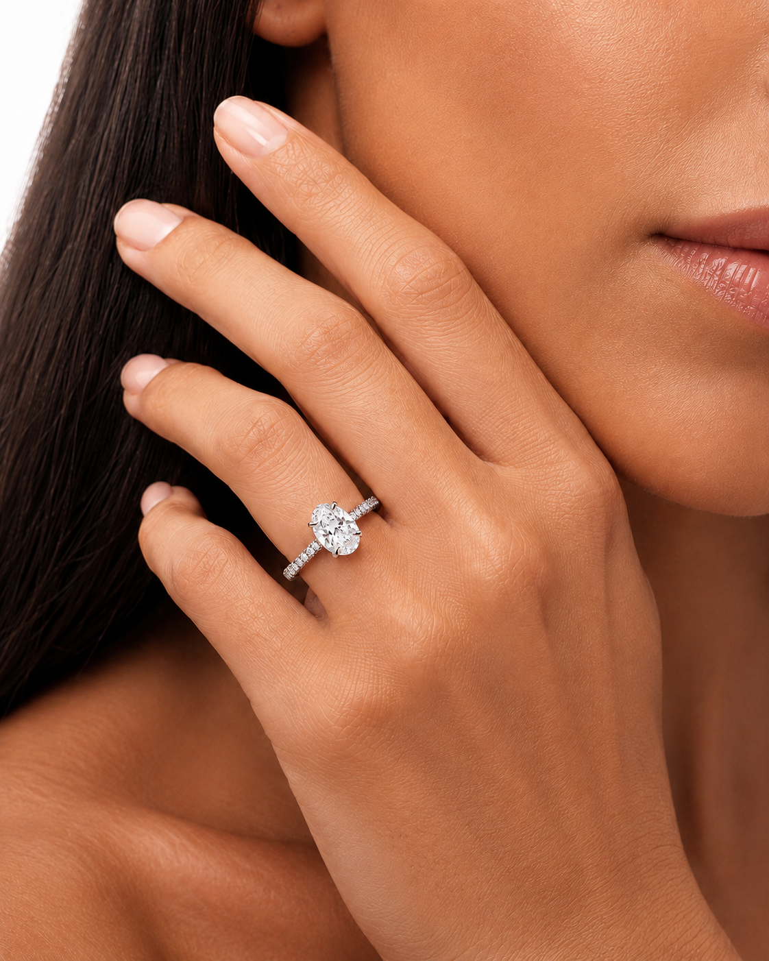 color_925_SIL,color_935_ARG,color_10K_WG, color_14K_WG &&	
A close-up lifestyle shot of a woman's hand wearing a silver-toned diamond engagement ring with a marquise-cut center stone and a pave band.