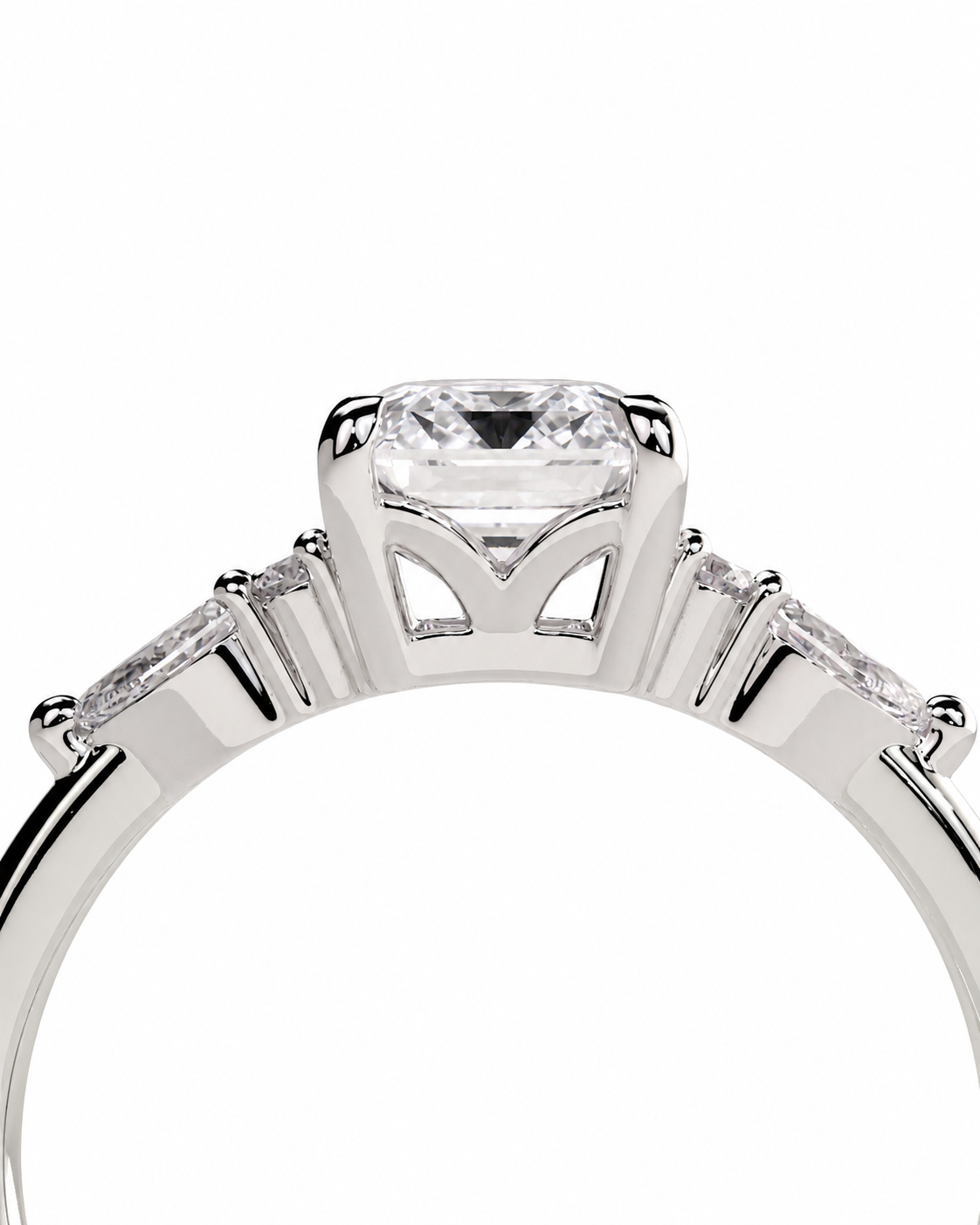 color_925_SIL,color_935_ARG,color_10K_WG, color_14K_WG &&A close-up studio shot of a silver-toned ring featuring a rectangular clear center stone and three smaller side stones on a white background.