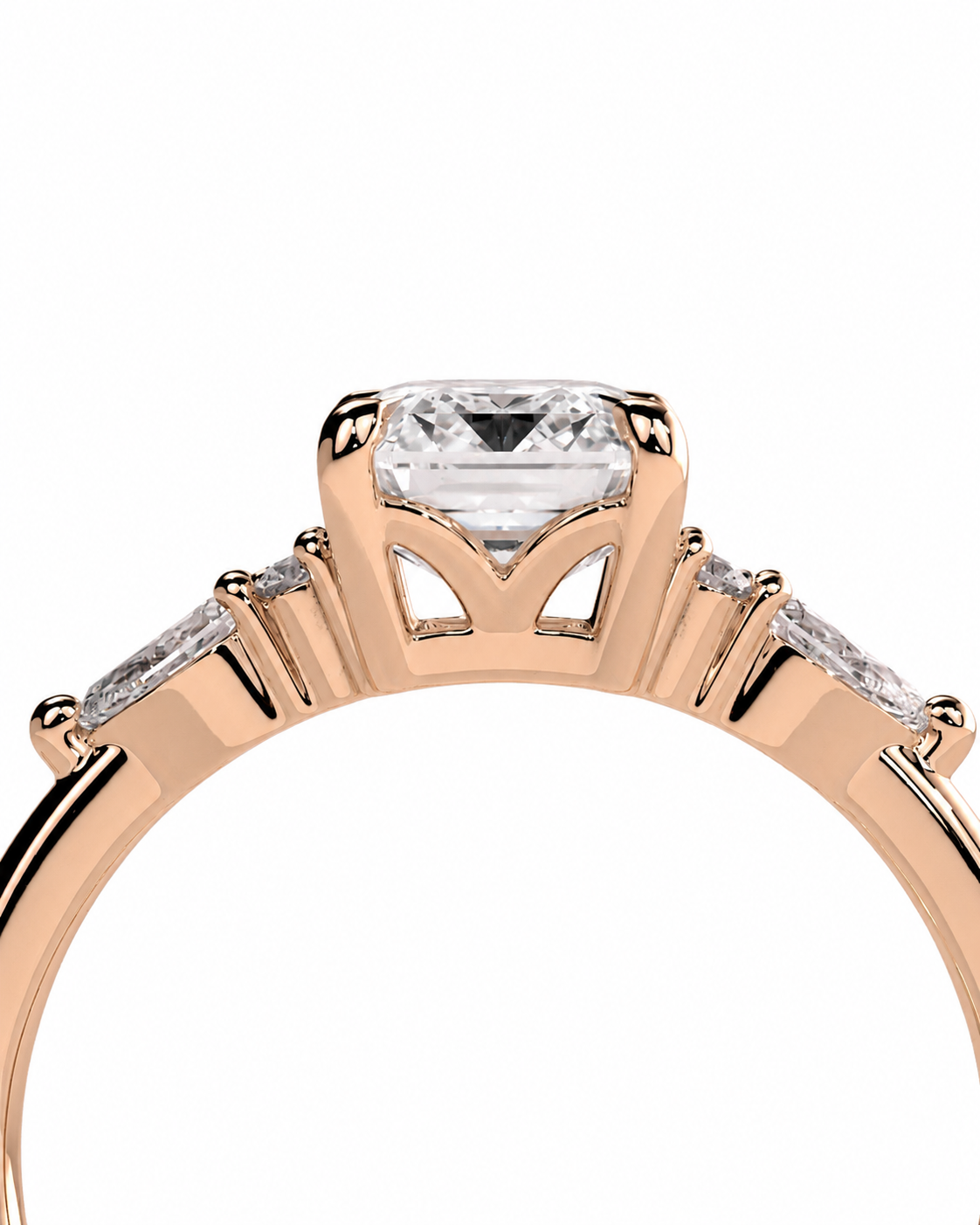 color_10K_RG, color_14K_RG &&Rose gold ring with a rectangular clear center stone and small side stones, shown in a close-up studio view on a white background.