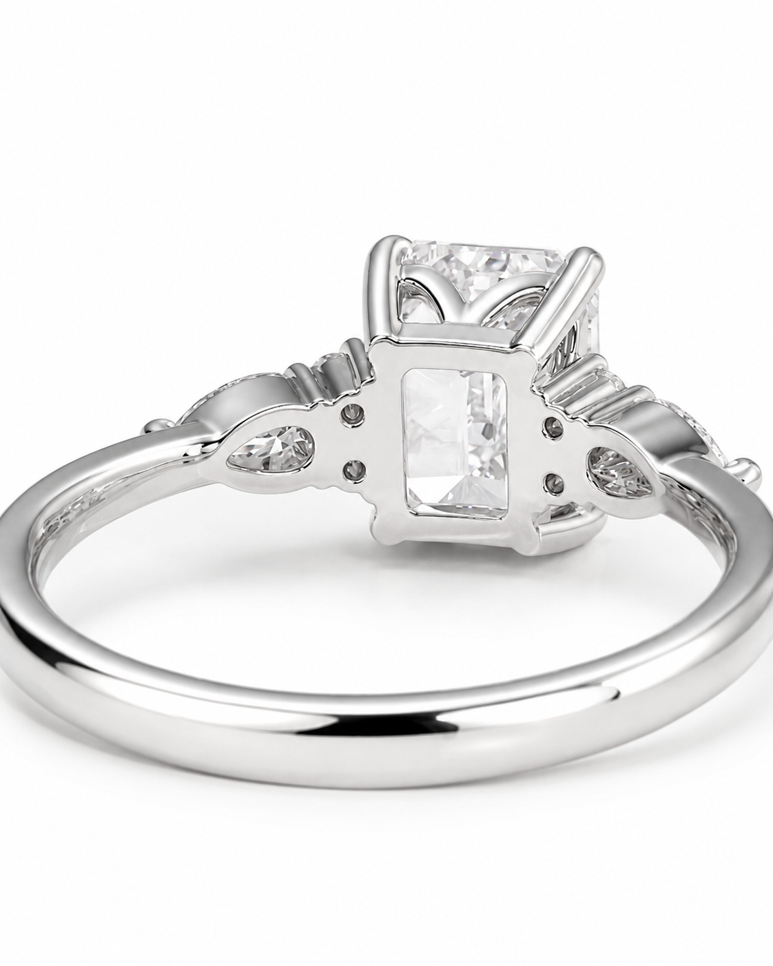 color_925_SIL,color_935_ARG,color_10K_WG, color_14K_WG &&A silver-toned diamond ring featuring a rectangular emerald-cut center stone and small round diamonds on the shoulders, shown on a clean white background.