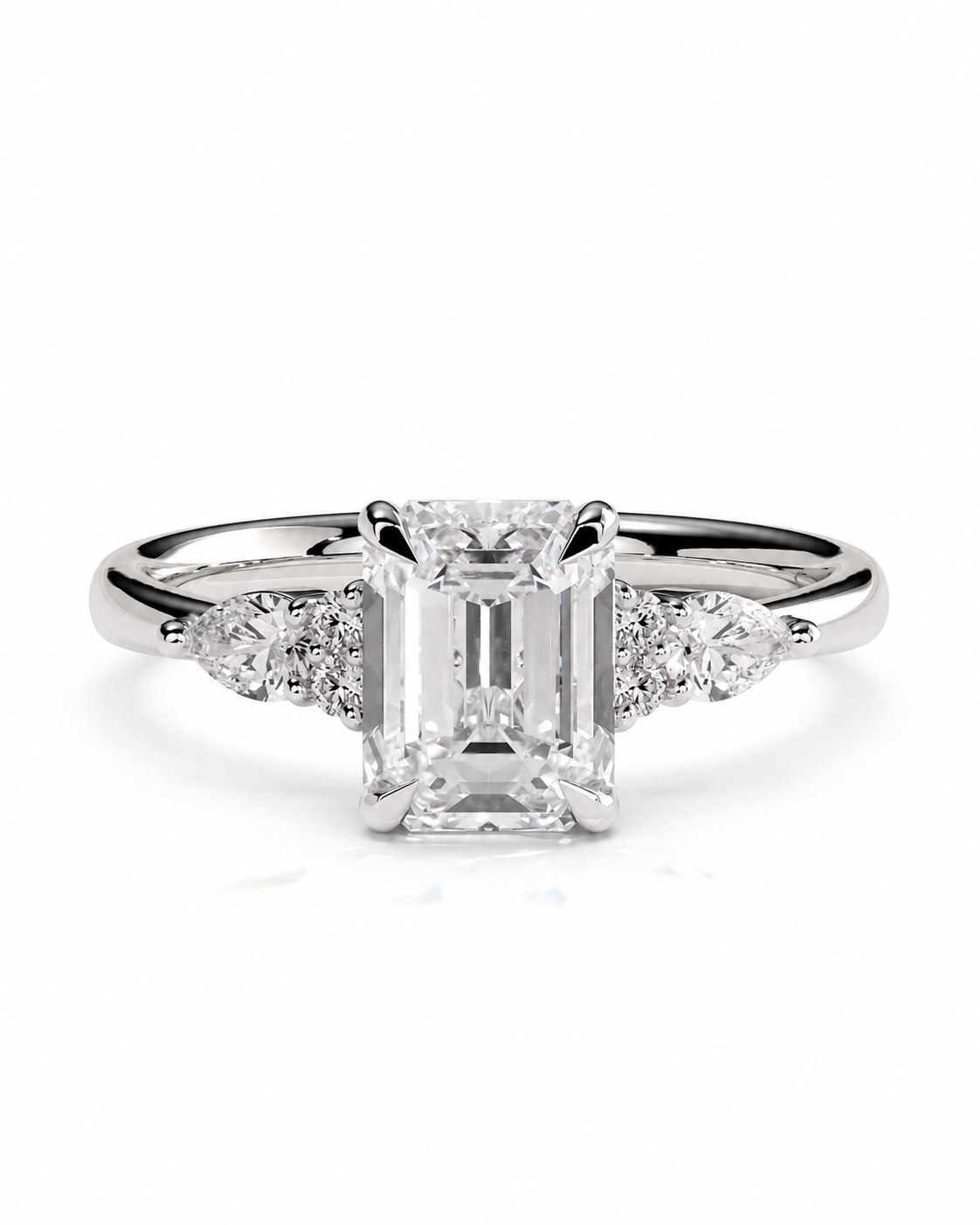 color_925_SIL,color_935_ARG,color_10K_WG, color_14K_WG &&An emerald-cut diamond engagement ring with a silver-colored band and small accent diamonds on either side, shown against a plain white background.