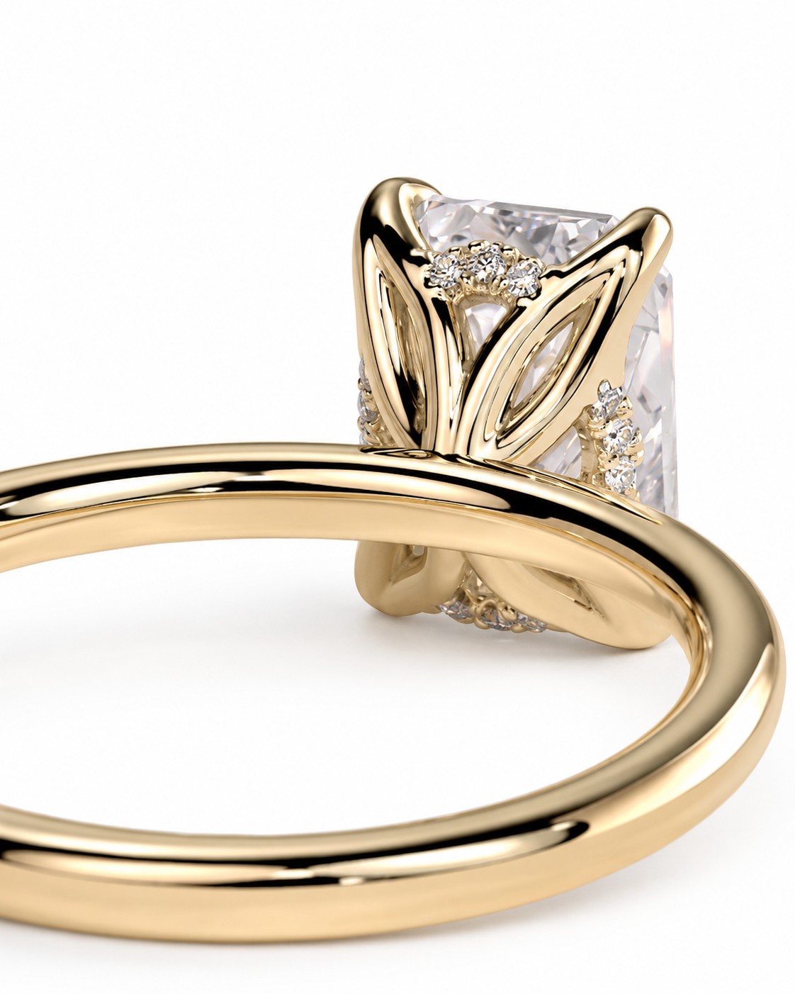 color_10K_YG, color_14K_YG &&
A close-up of a yellow gold ring featuring a large rectangular clear gemstone in a prong setting with smaller accent stones along the band, shown on a white background.