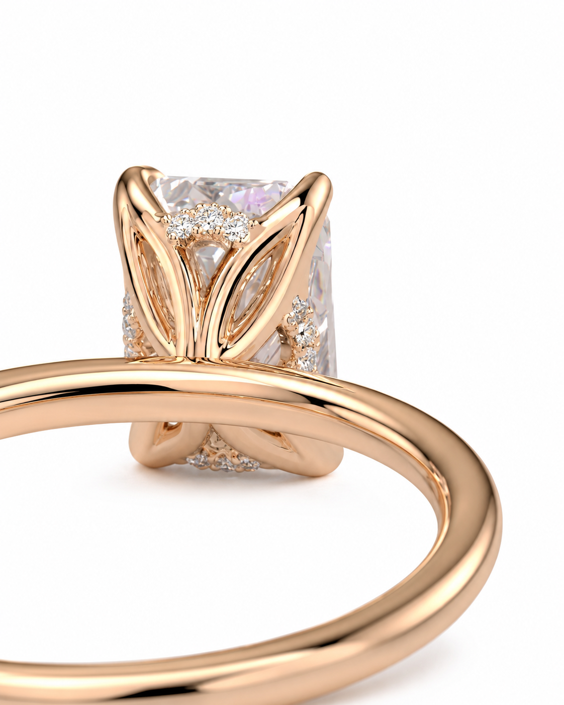 color_10K_RG, color_14K_RG &&
A close-up of a rose gold ring featuring a rectangular clear gemstone in a leaf-like setting with small accent stones, shown against a plain white background.