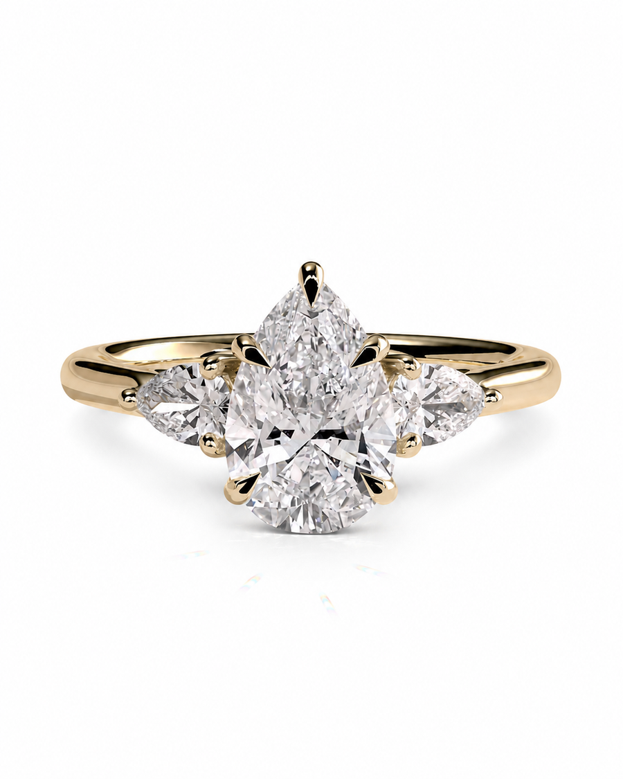 color_10K_YG, color_14K_YG &&A yellow gold ring featuring a central pear-cut diamond surrounded by smaller marquise-cut diamonds on the shoulders, set against a clean white background.