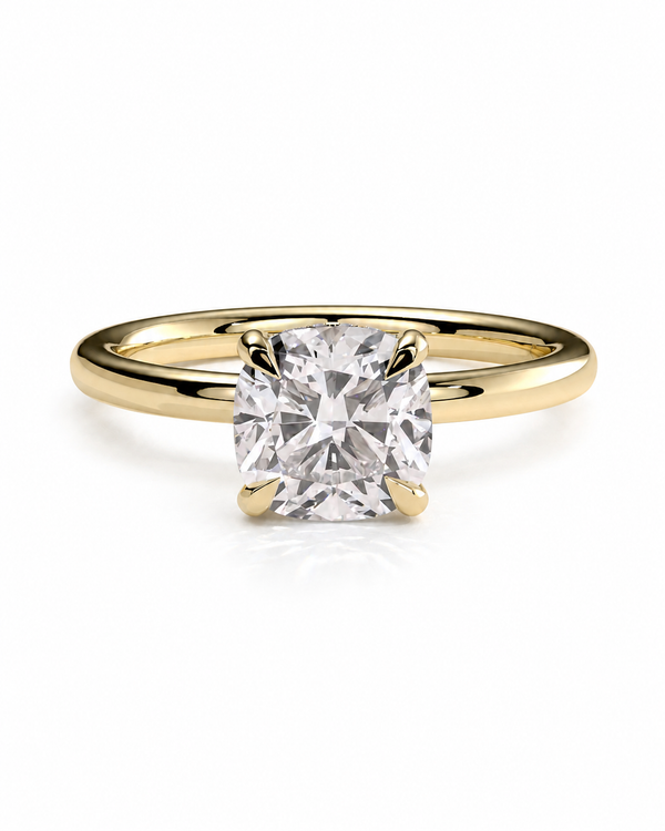 color_10K_YG, color_14K_YG &&A yellow gold solitaire engagement ring featuring a cushion-cut diamond in a four-prong setting, shown on a clean white background.
