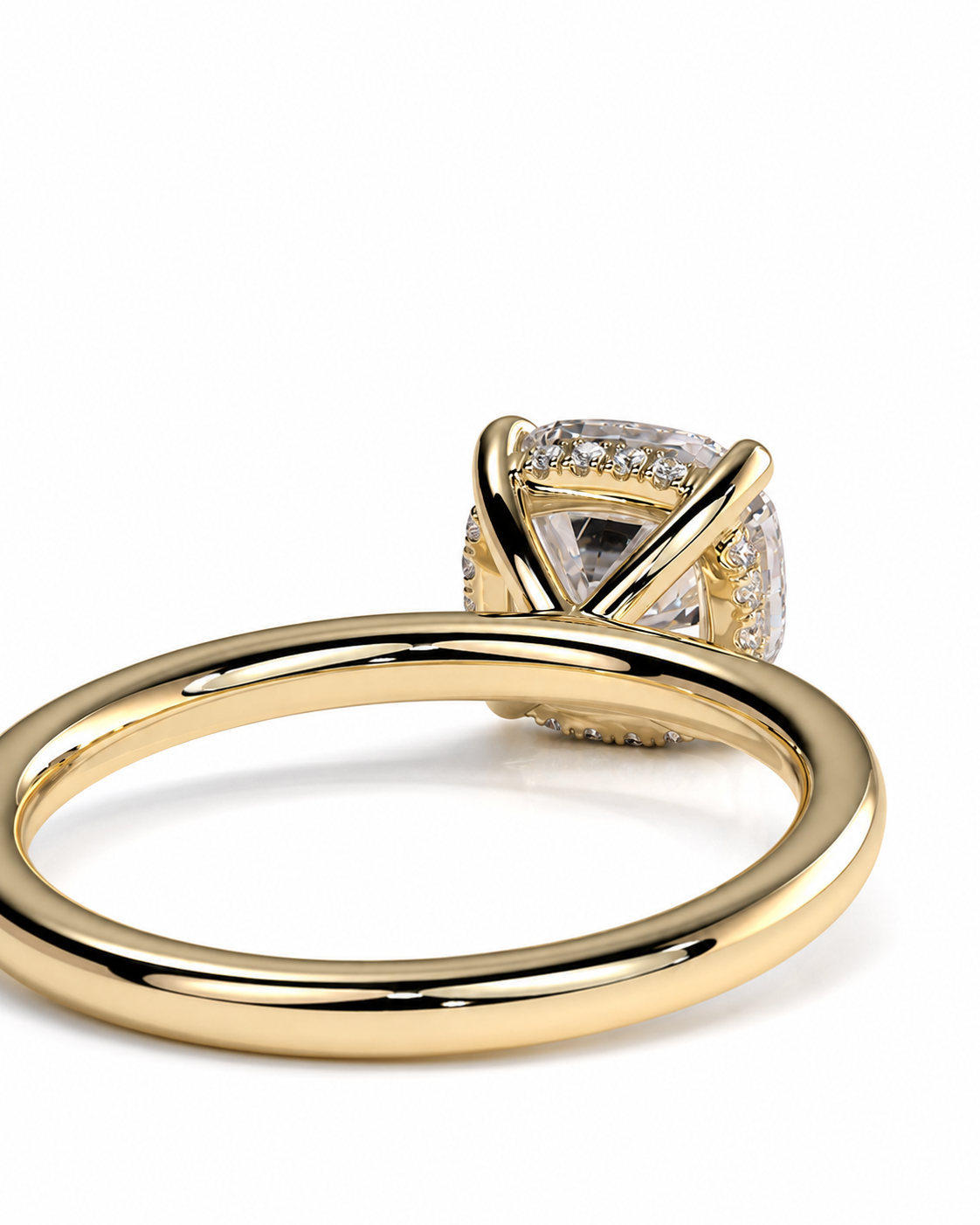 color_10K_YG, color_14K_YG &&A close-up shot of a gold ring with a large clear cushion-cut center stone and small accent stones, set against a plain white background.
