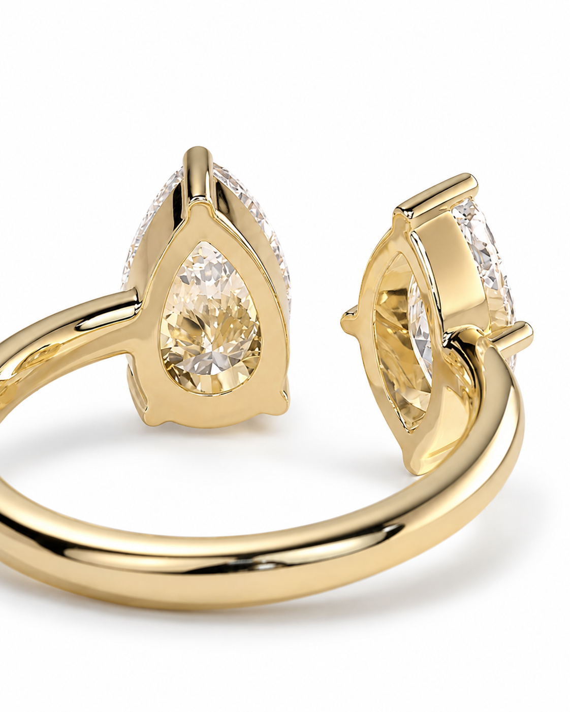 color_10K_YG, color_14K_YG &&A close-up studio shot of a gold ring with pear-cut clear gemstones, showing both the front and side profile against a clean white background.