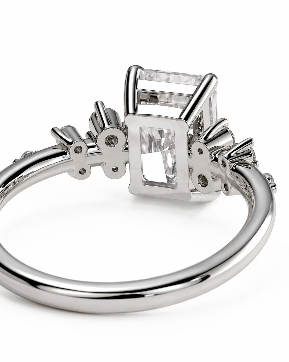 color_925_SIL,color_935_ARG,color_10K_WG, color_14K_WG &&A silver-toned ring featuring a rectangular clear gemstone in a square bezel setting, with smaller accent stones along the band, shown on a white background.