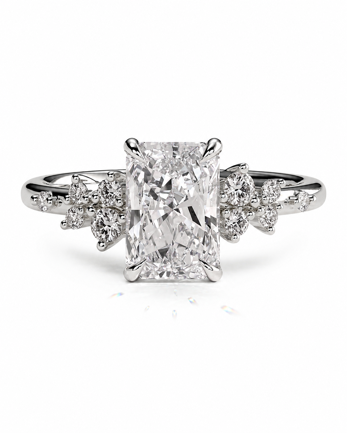 color_925_SIL,color_935_ARG,color_10K_WG, color_14K_WG &&An emerald-cut diamond engagement ring with a radiant center stone and diamond-accented shank, set in a silver-colored metal on a white background.