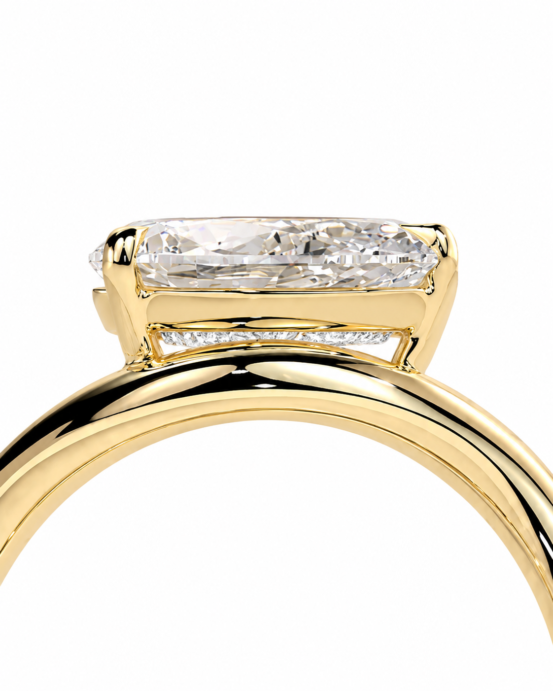 color_10K_YG, color_14K_YG &&A close-up of a yellow gold ring featuring a rectangular baguette-cut clear gemstone in a prong setting, with a small channel of round diamonds along the band, set against a plain white background.