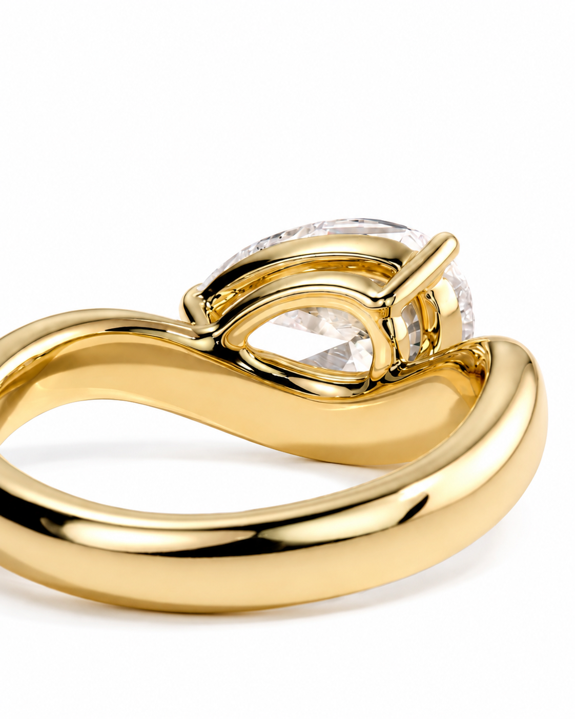 color_10K_YG, color_14K_YG &&A close-up shot of a yellow gold ring with a clear teardrop-cut gemstone in a prong setting, shown against a plain white background.