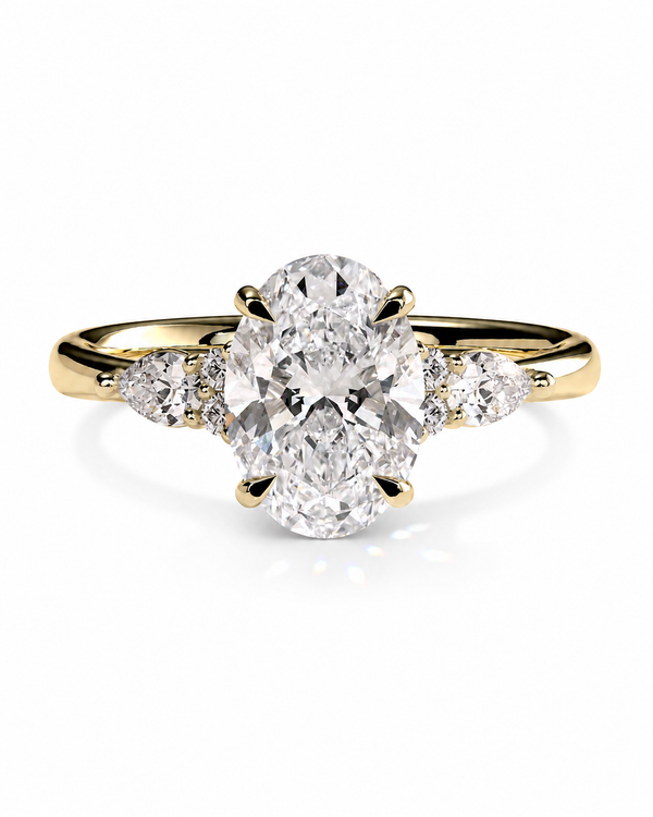 color_10K_YG, color_14K_YG &&A yellow gold diamond ring with a large oval center stone and smaller round diamonds on either side of the band, shown on a clean white background.