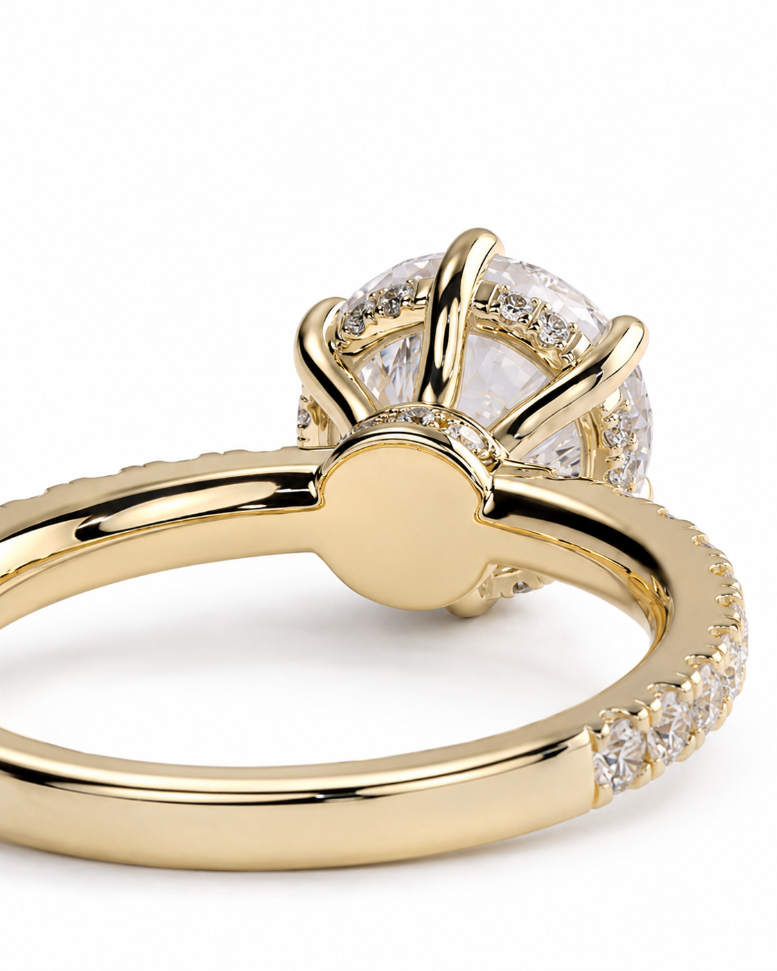 color_10K_YG, color_14K_YG &&A close-up shot of a yellow gold ring with a round brilliant-cut diamond center stone and a halo of smaller diamonds, set against a clean white background.