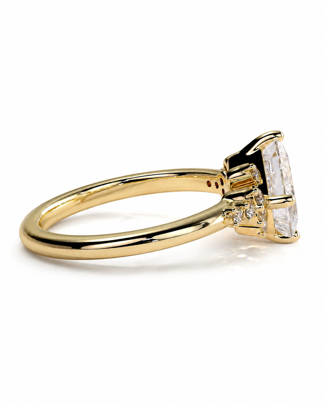 color_10K_YG, color_14K_YG &&A yellow gold ring with a large emerald-cut clear center stone and smaller side stones, shown on a clean white background.