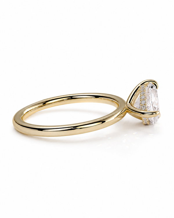 color_10K_YG, color_14K_YG &&A gold ring with a triangular bezel setting holding a clear marquise-cut gemstone, photographed on a clean white background.