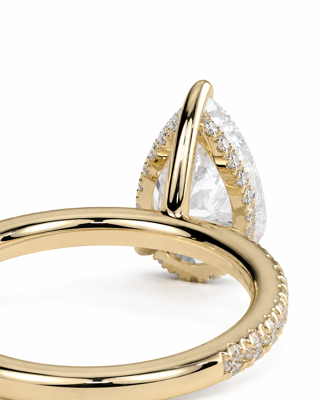 color_10K_YG, color_14K_YG &&A close-up of a gold ring featuring a large teardrop-shaped clear gemstone in a prong setting, accented with small clear stones along the band, on a white background.