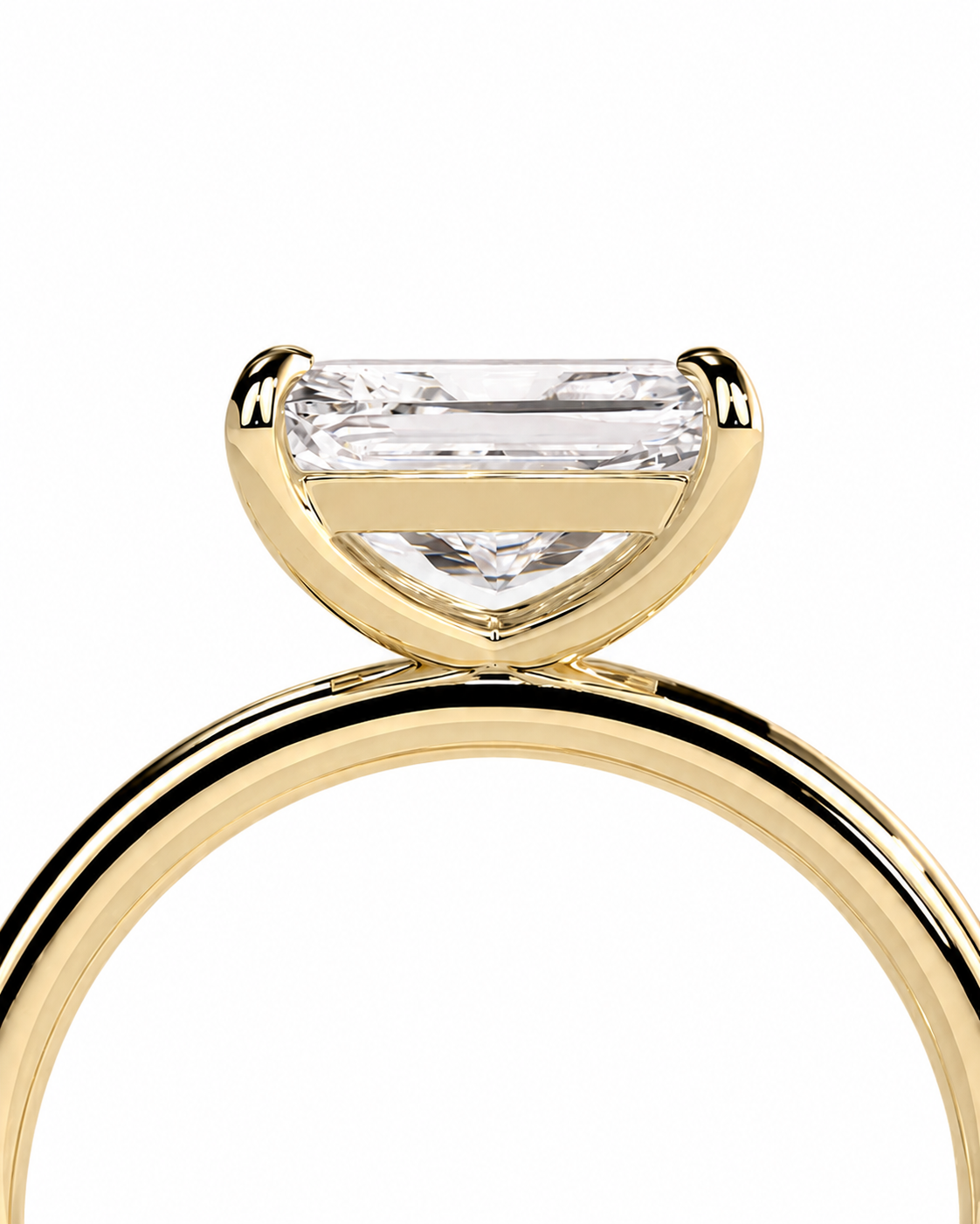 color_10K_YG, color_14K_YG &&A close-up of a yellow gold ring featuring a large, bezel-set clear baguette-cut diamond on a white background.