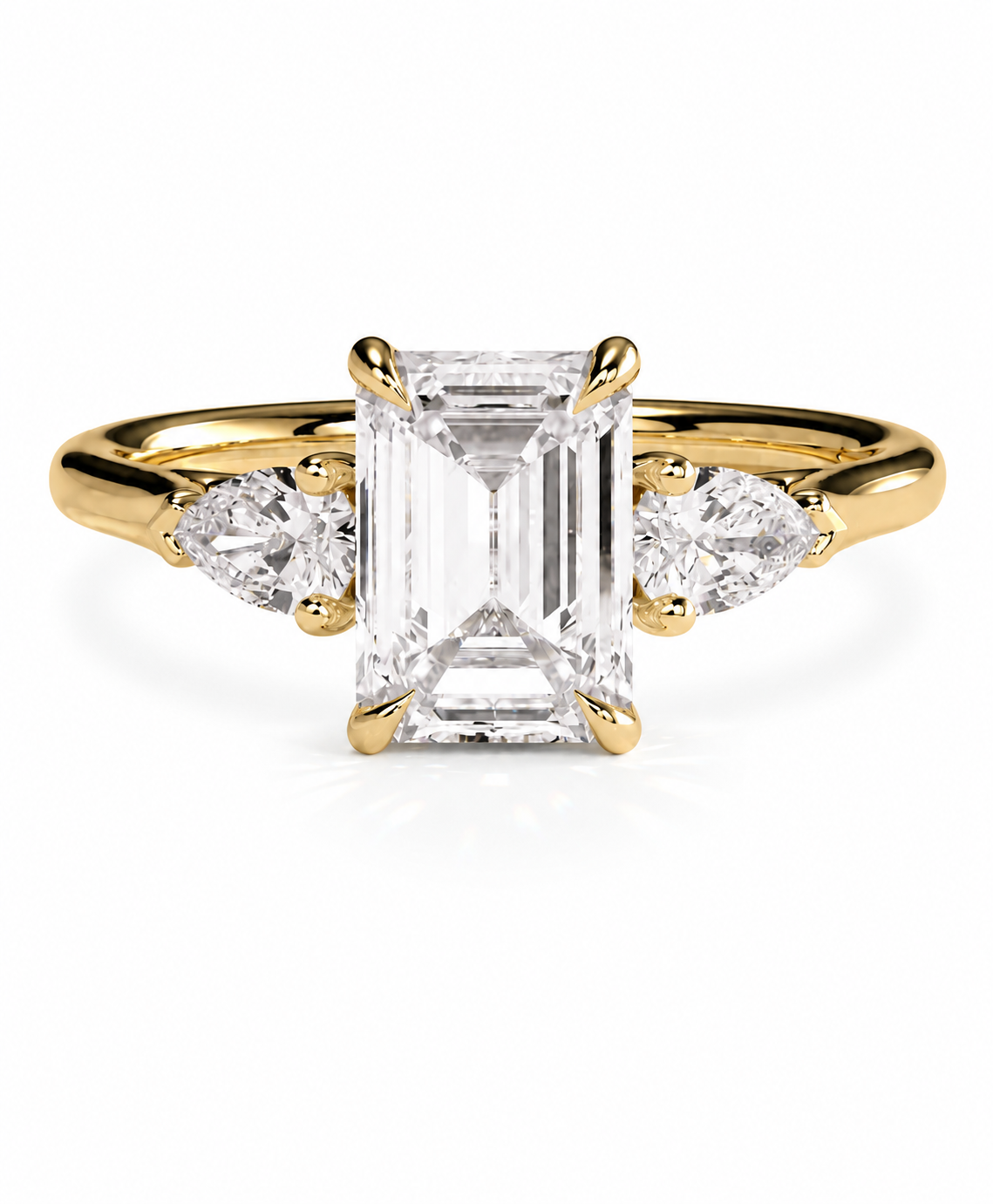 color_10K_YG, color_14K_YG &&A yellow gold three-stone ring featuring a large rectangular emerald-cut center diamond flanked by two smaller round diamonds on a white background.