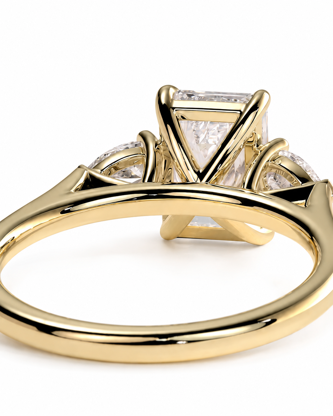 color_10K_YG, color_14K_YG &&A close-up shot of a yellow gold ring with a geometric triangular cluster setting featuring clear gemstones, shown on a plain white background.