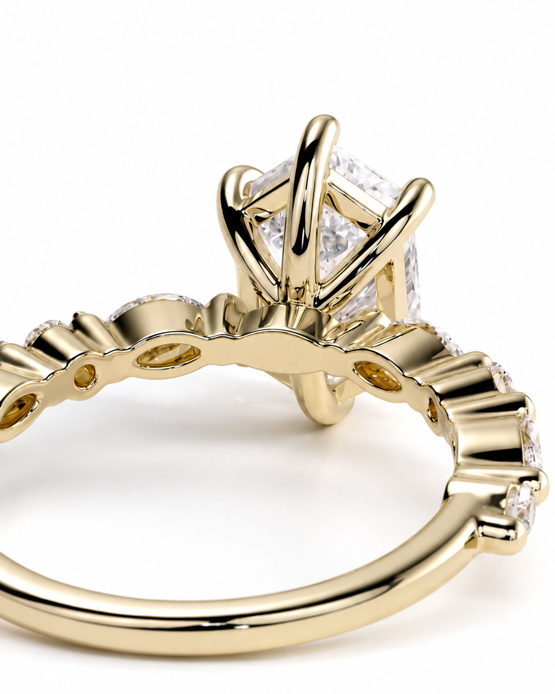 color_10K_YG, color_14K_YG &&A close-up of a yellow gold ring with a large clear gemstone in a prong setting and a decorative band with small accent stones, shown on a white background.
