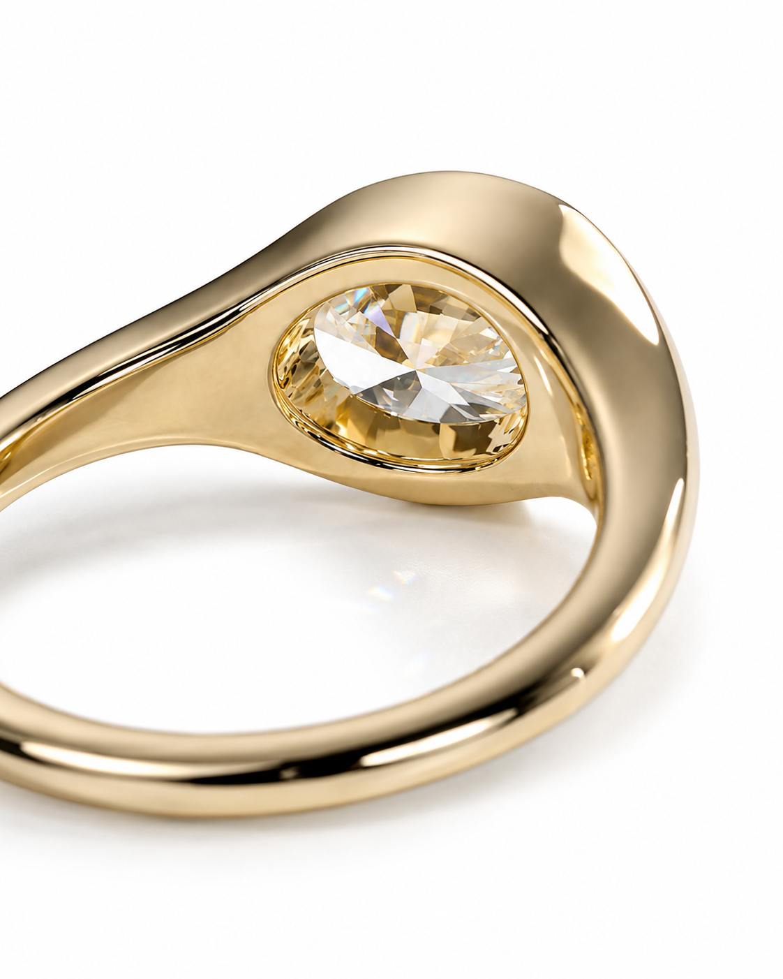 color_10K_YG, color_14K_YG &&A close-up of a polished yellow gold ring featuring a bezel-set round clear gemstone on a white background.