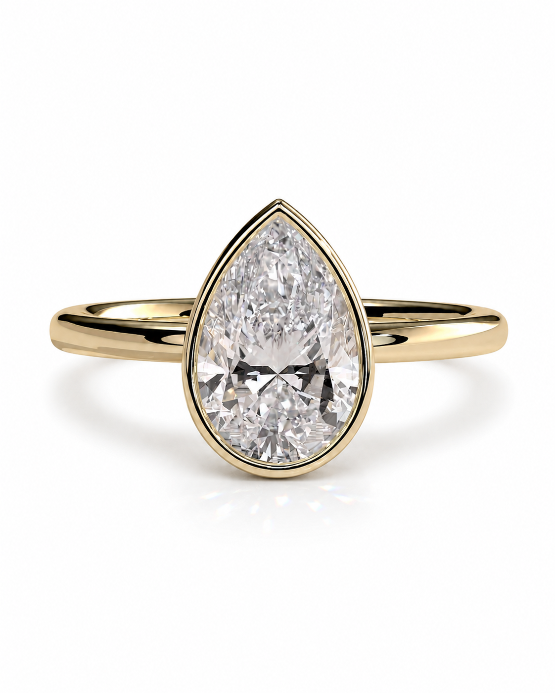 color_10K_YG, color_14K_YG &&A pear-cut diamond engagement ring in a yellow gold band, shown on a clean white background with a soft reflection.
