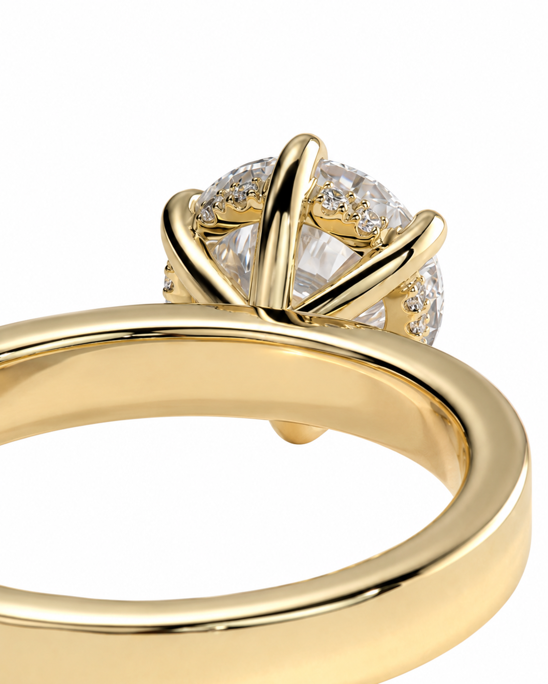 color_10K_YG, color_14K_YG &&A close-up of a yellow gold ring with a brilliant round-cut diamond center stone and smaller side diamonds, set in a polished four-prong style on a white background.