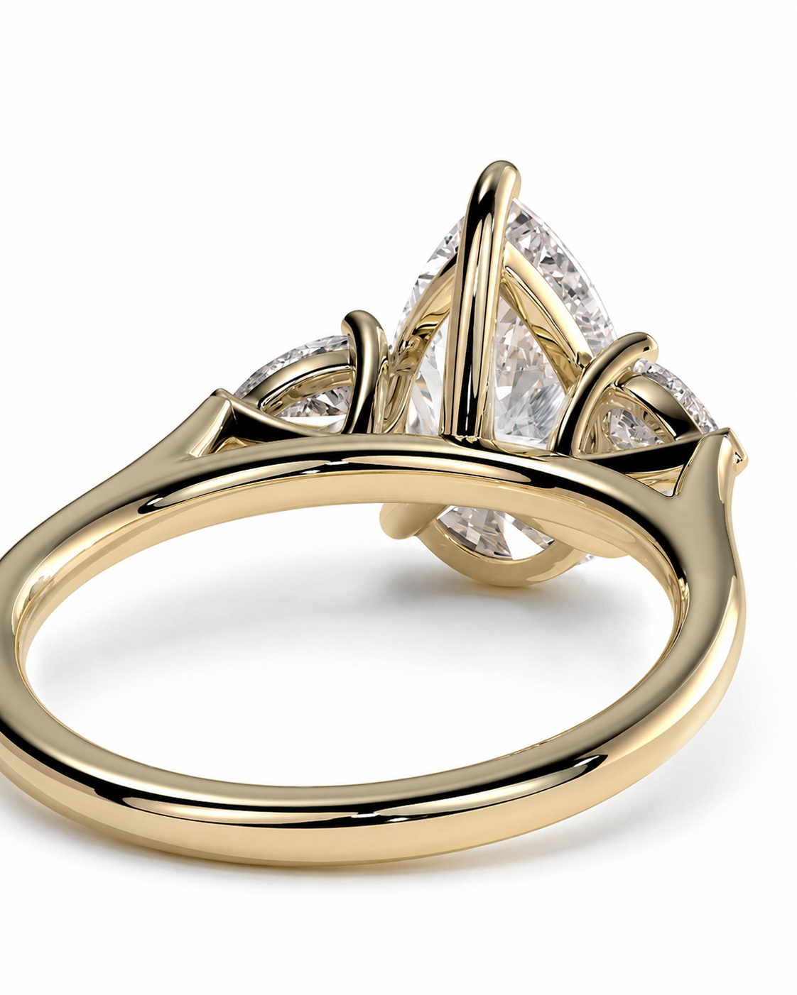 color_10K_YG, color_14K_YG &&A close-up shot of a yellow gold ring featuring a pear-cut diamond center stone and smaller diamonds along the shoulders, set against a clean white background.