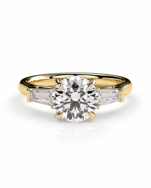 color_10K_YG, color_14K_YG &&A yellow gold engagement ring featuring a round brilliant-cut center stone and two baguette-cut side stones, shown on a clean white background.