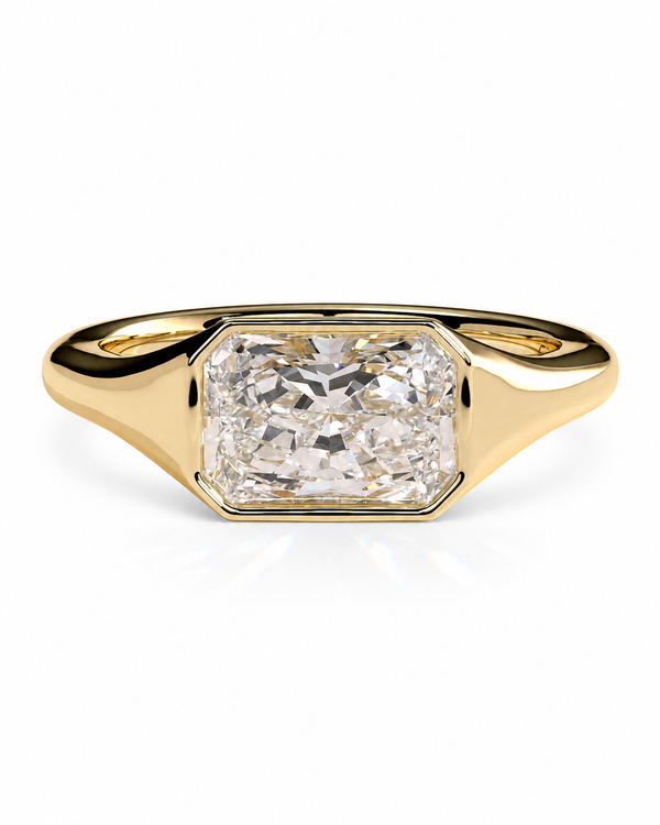 color_10K_YG, color_14K_YG &&A yellow gold ring featuring a large, bezel-set rectangular radiant-cut diamond on a clean white background.
