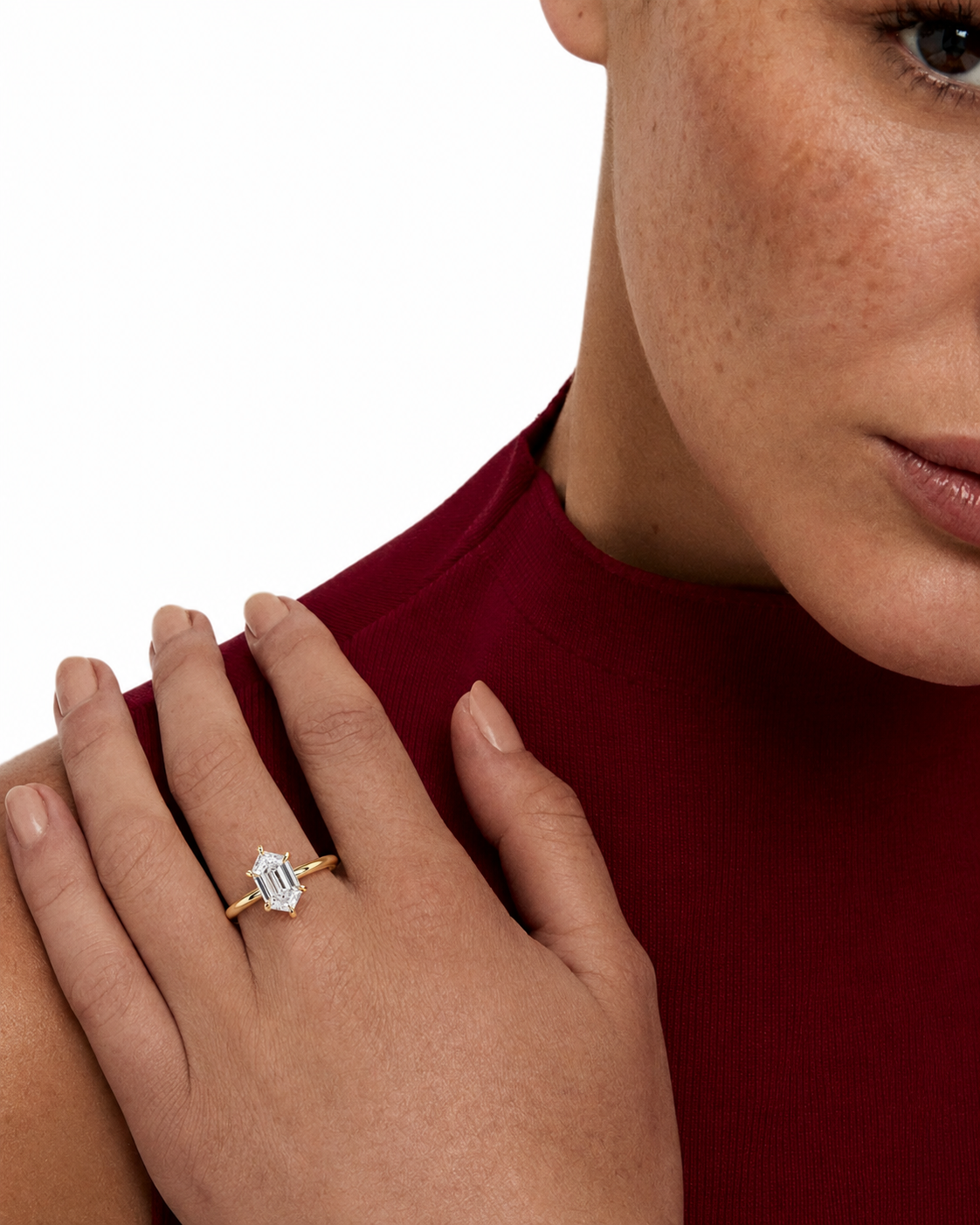 color_10K_YG, color_14K_YG &&A close-up lifestyle shot of a model wearing a gold ring with a rectangular cluster of clear baguette-cut gemstones on her finger, set against a clean white background.