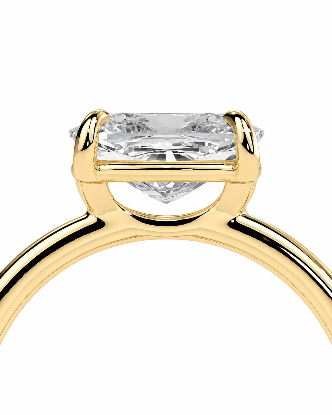 color_10K_YG, color_14K_YG &&
A close-up of a yellow gold ring with a rectangular clear gemstone in a prong setting, shown against a plain white background.