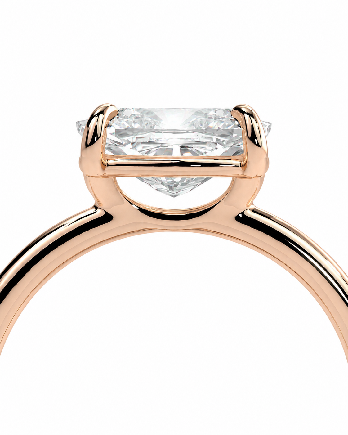 color_10K_RG, color_14K_RG &&
Close-up of a rose gold ring with a rectangular clear gemstone in a four-prong setting, shown against a plain white background.