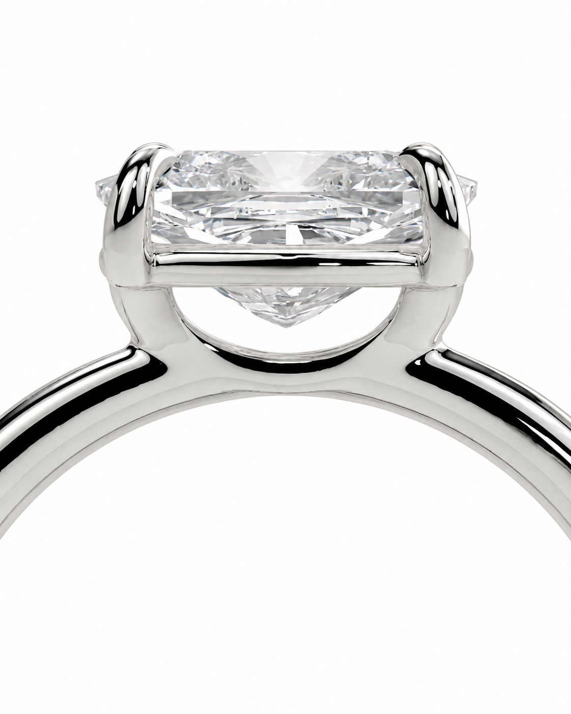 color_925_SIL,color_935_ARG,color_10K_WG, color_14K_WG &&
A close-up studio shot of a solitaire engagement ring featuring a rectangular princess-cut diamond set in a polished silver-colored band, shown against a solid white background.