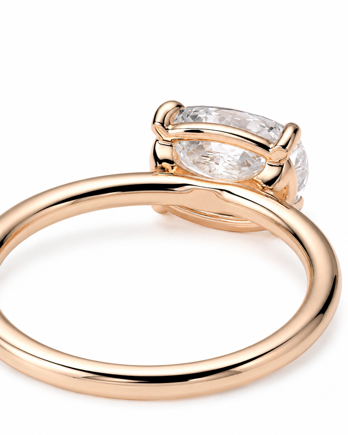 color_10K_RG, color_14K_RG &&
A close-up shot of a rose gold ring with a marquise-cut clear gemstone in a prong setting, shown on a clean white background.