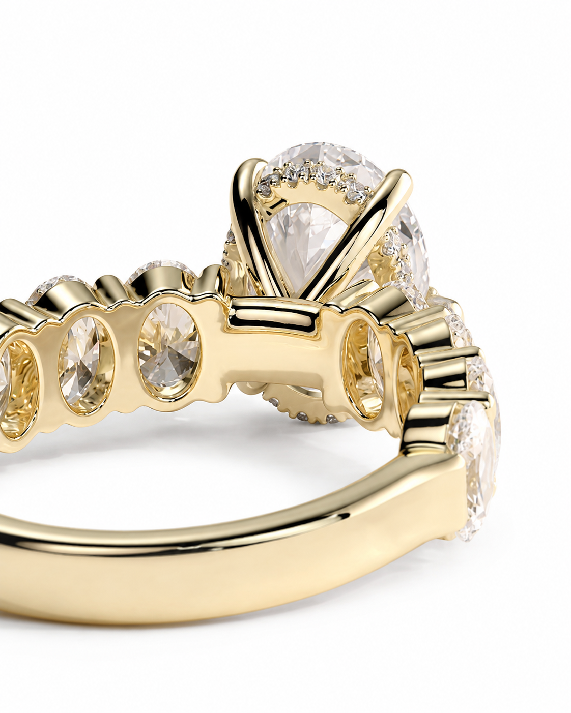 color_10K_YG, color_14K_YG &&A close-up of a yellow gold ring featuring a large pear-cut center stone and smaller round stones along the band, set against a plain white background.