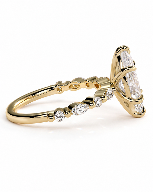 color_10K_YG, color_14K_YG &&A yellow gold ring featuring a large marquise-cut clear center stone and smaller round and marquise-cut accent stones along the band, shown on a clean white background.