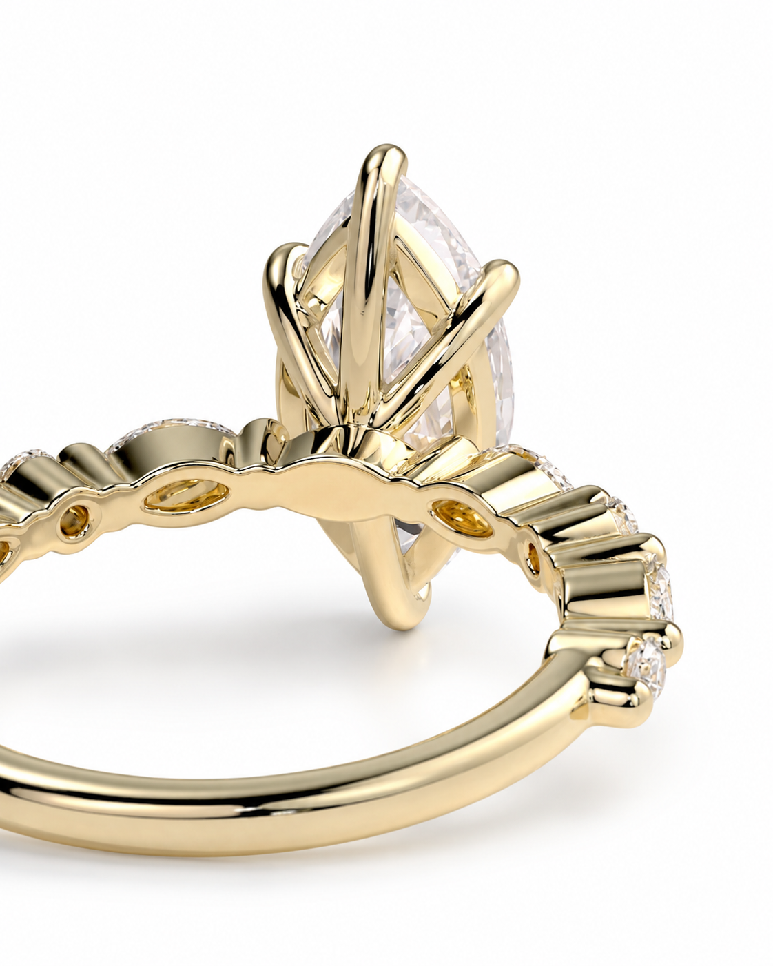 color_10K_YG, color_14K_YG &&A close-up of a yellow gold ring featuring a marquise-cut clear gemstone in a claw setting, with smaller accent stones along the band, shown on a white background.