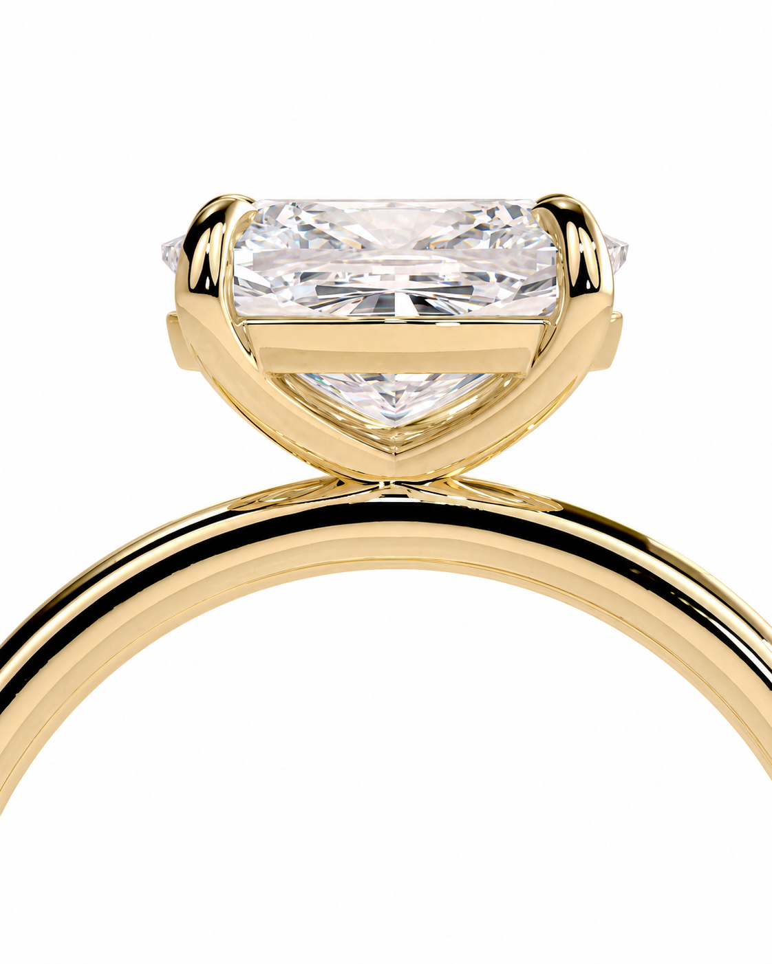 color_10K_YG, color_14K_YG &&A close-up of a yellow gold ring featuring a large rectangular princess-cut diamond center stone in a four-prong setting, with a small accent diamond on each side, shown against a plain white background.